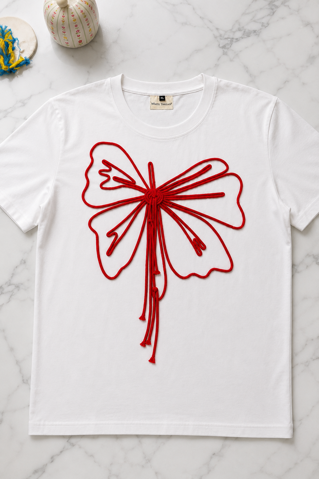 Close-up of the Butterfly Knot Women's T-Shirt highlighting the handcrafted butterfly cord detailing on French Terry fabric.