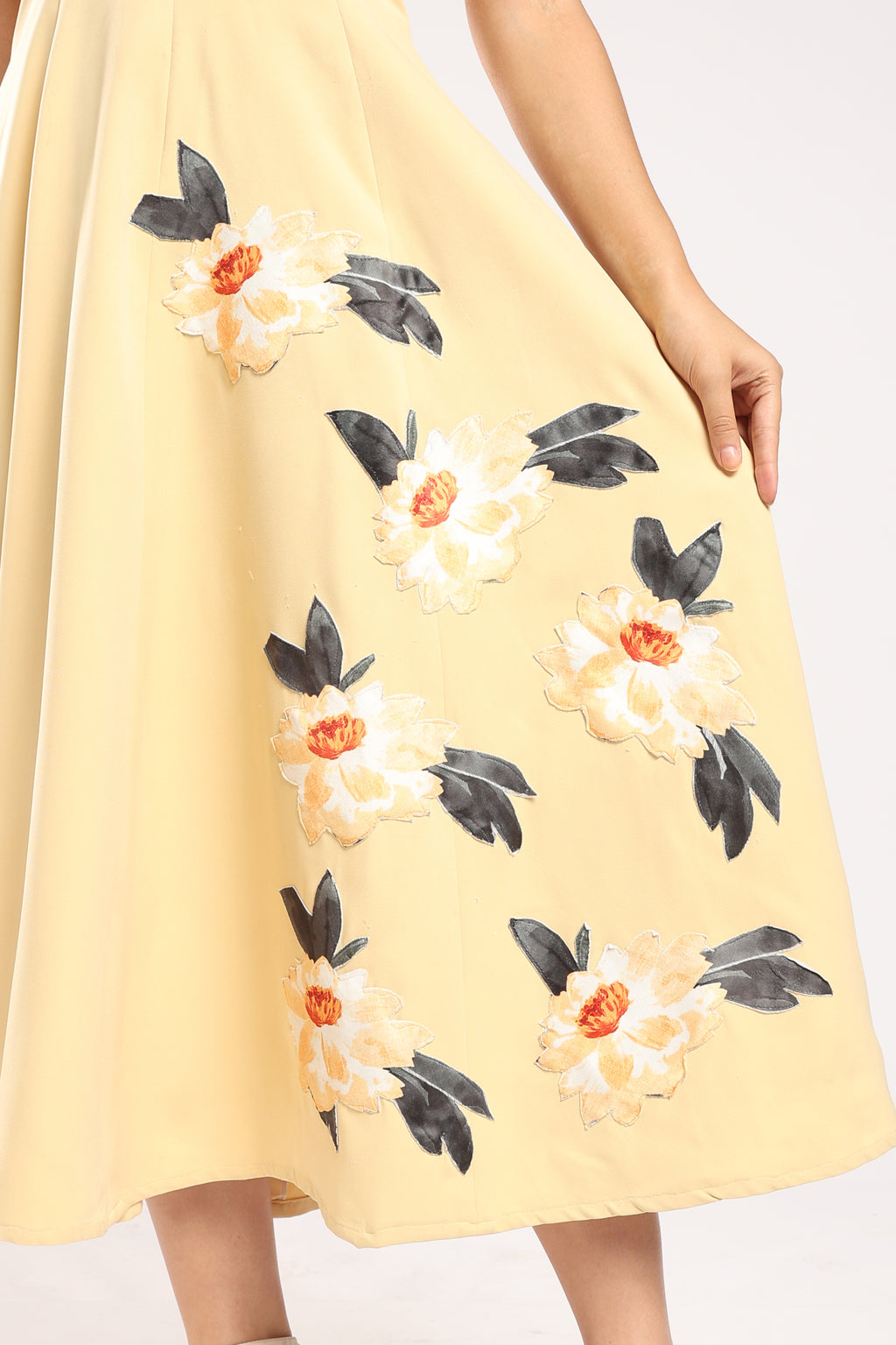Clouser look at handcrafted appliqué detailing.