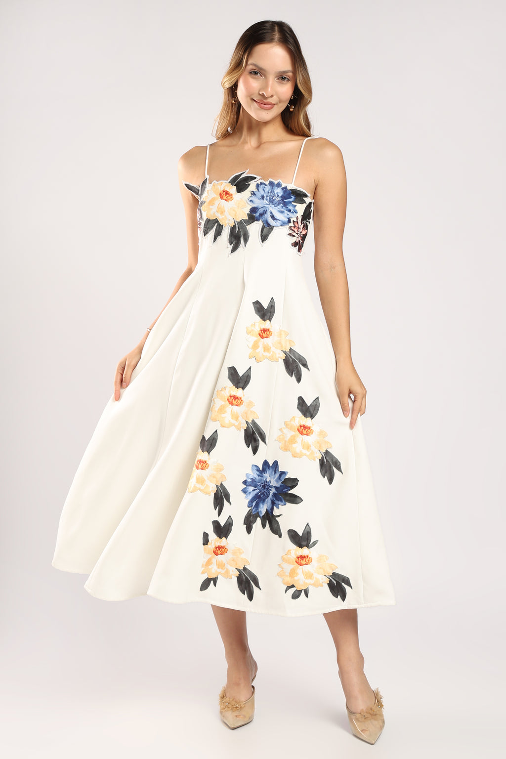 Front view of The Garden Dress showing its flowy silhouette in ivory imported crepe.