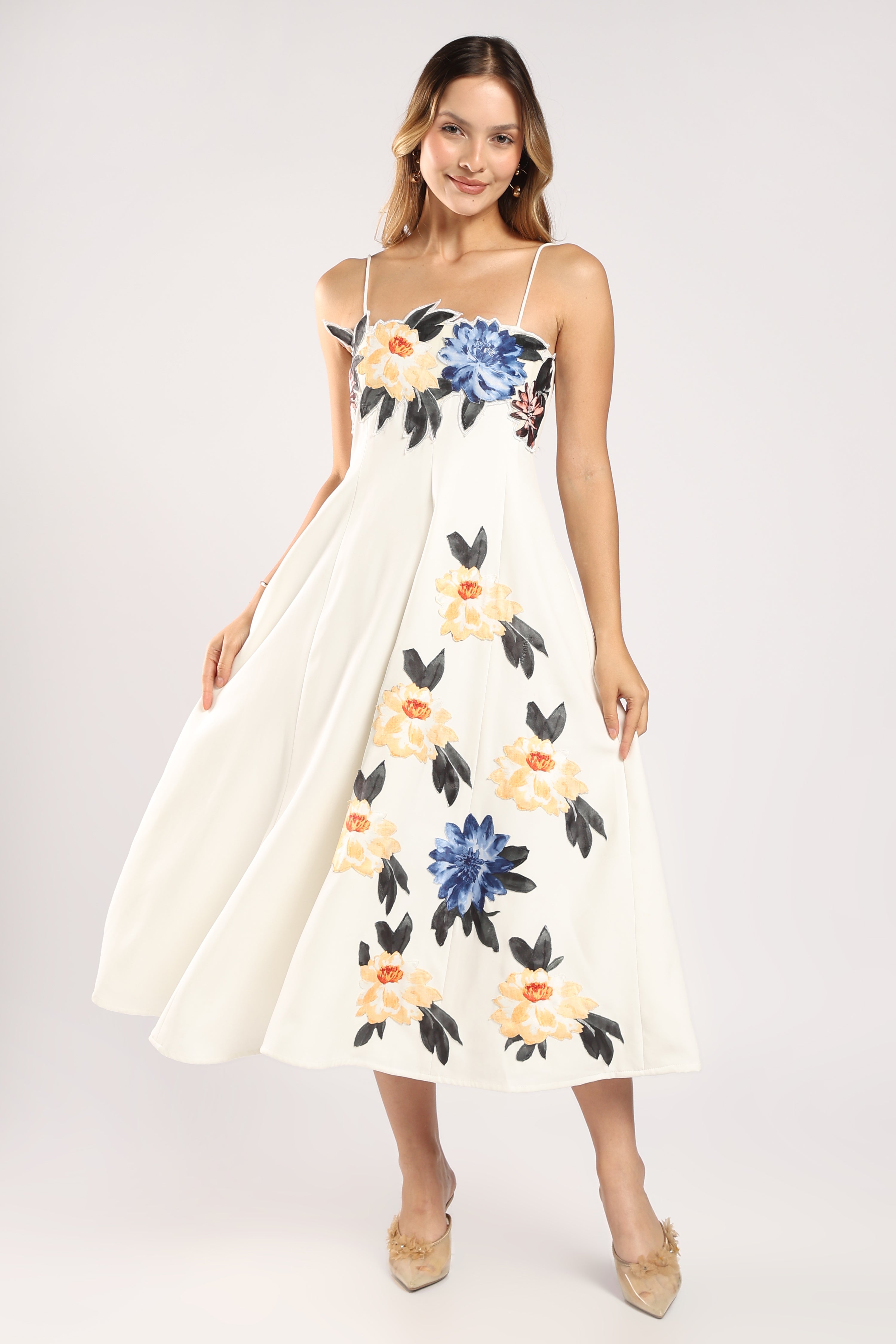 Front view of The Garden Dress showing its flowy silhouette in ivory imported crepe.