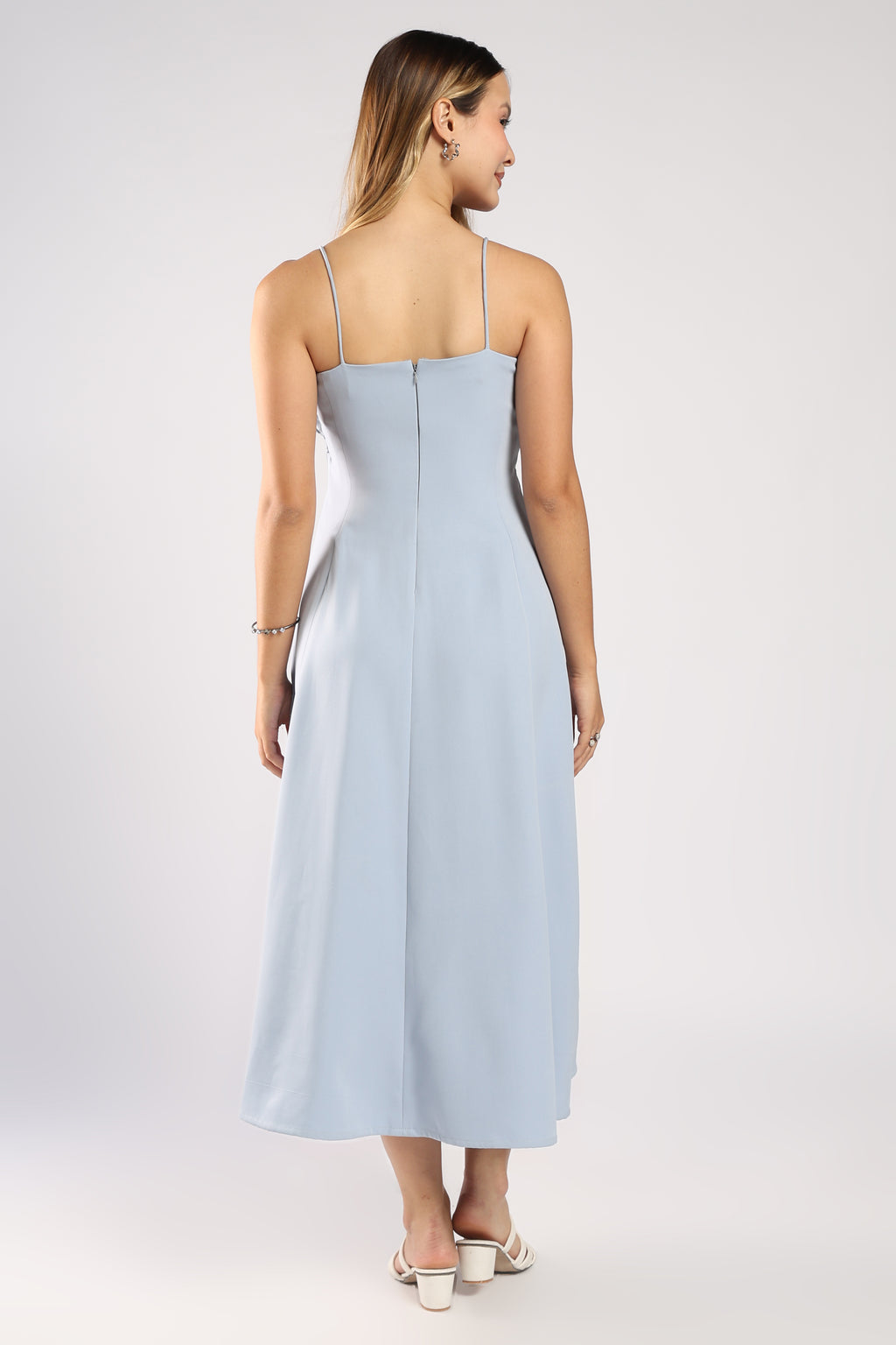 Back view of The Bluebell Ice Blue Women's Dress showing the zip closure and flowing fit.