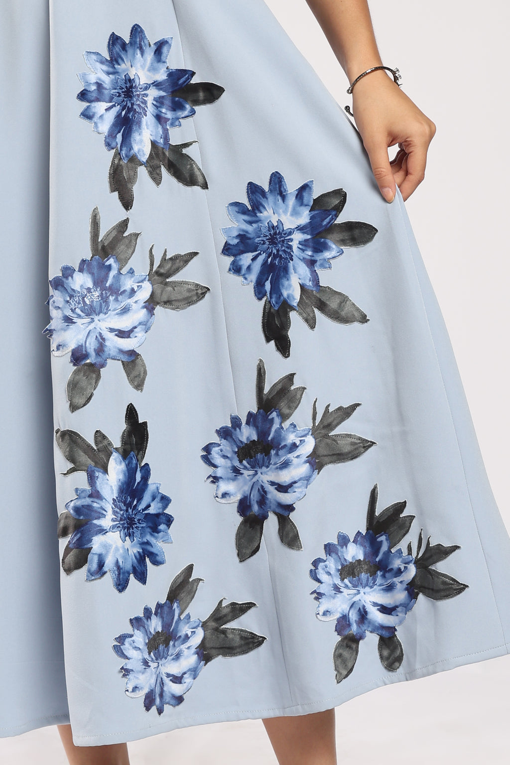 The Bluebell Ice Blue Women's Dress featuring handcrafted appliqué detailing.