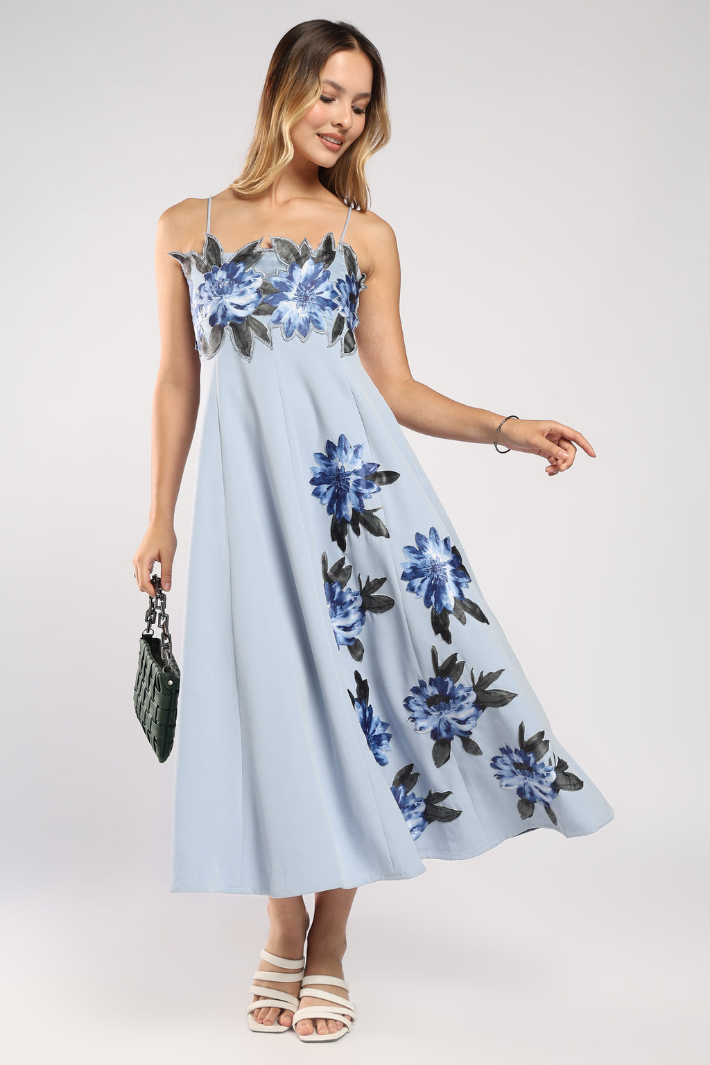 Front view of The Bluebell Dress showing its flowy silhouette in ice blue imported crepe.