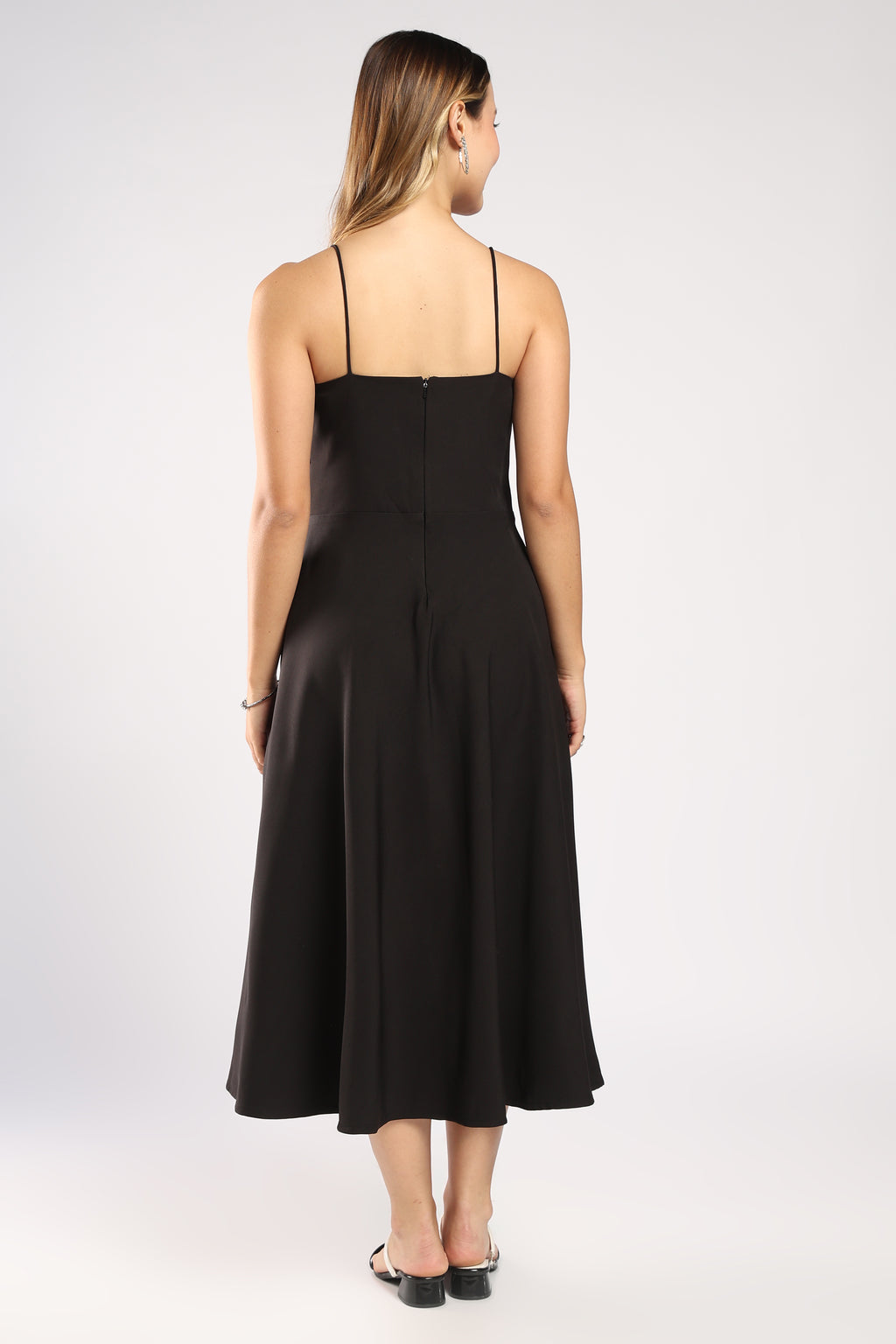 The Moon Women's Black Dress showcasing its black colour, back side and sleek zip closure.