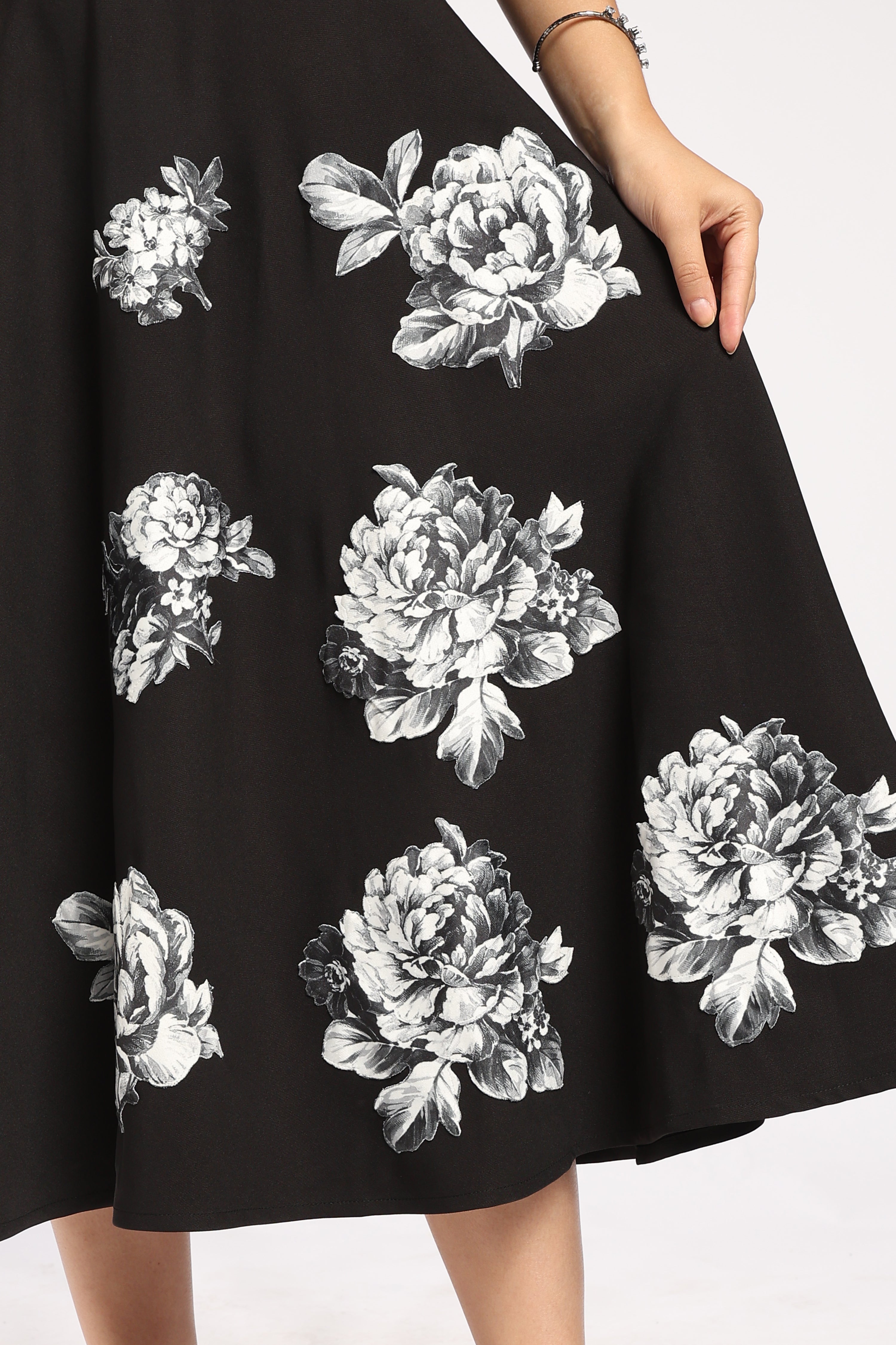 The Moon Women's Black Dress featuring handcrafted appliqué detailing at the bottom.