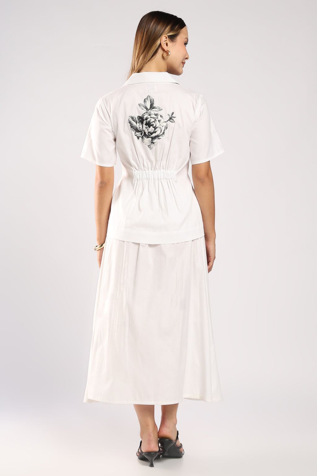 The Flora White Women's Skirt Set back side featuring handcrafted appliqué detailing on the top and the elastic 