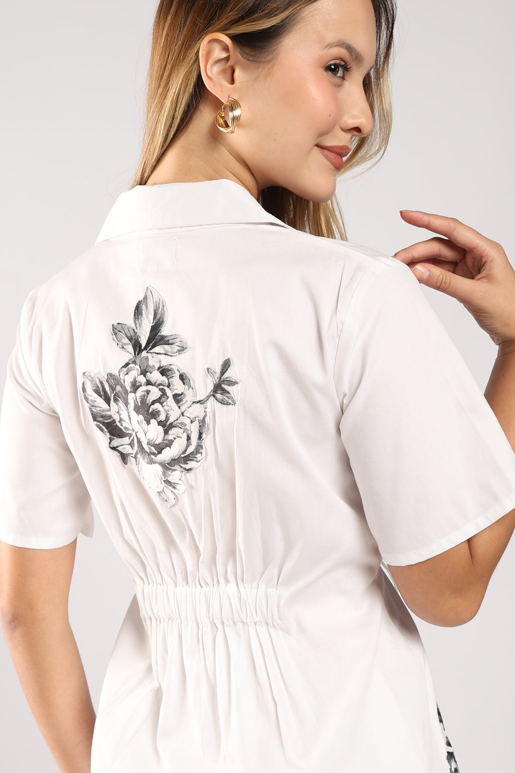 The Flora White Women's Skirt Set back side featuring handcrafted appliqué detailing on the top and the elastic detailing.