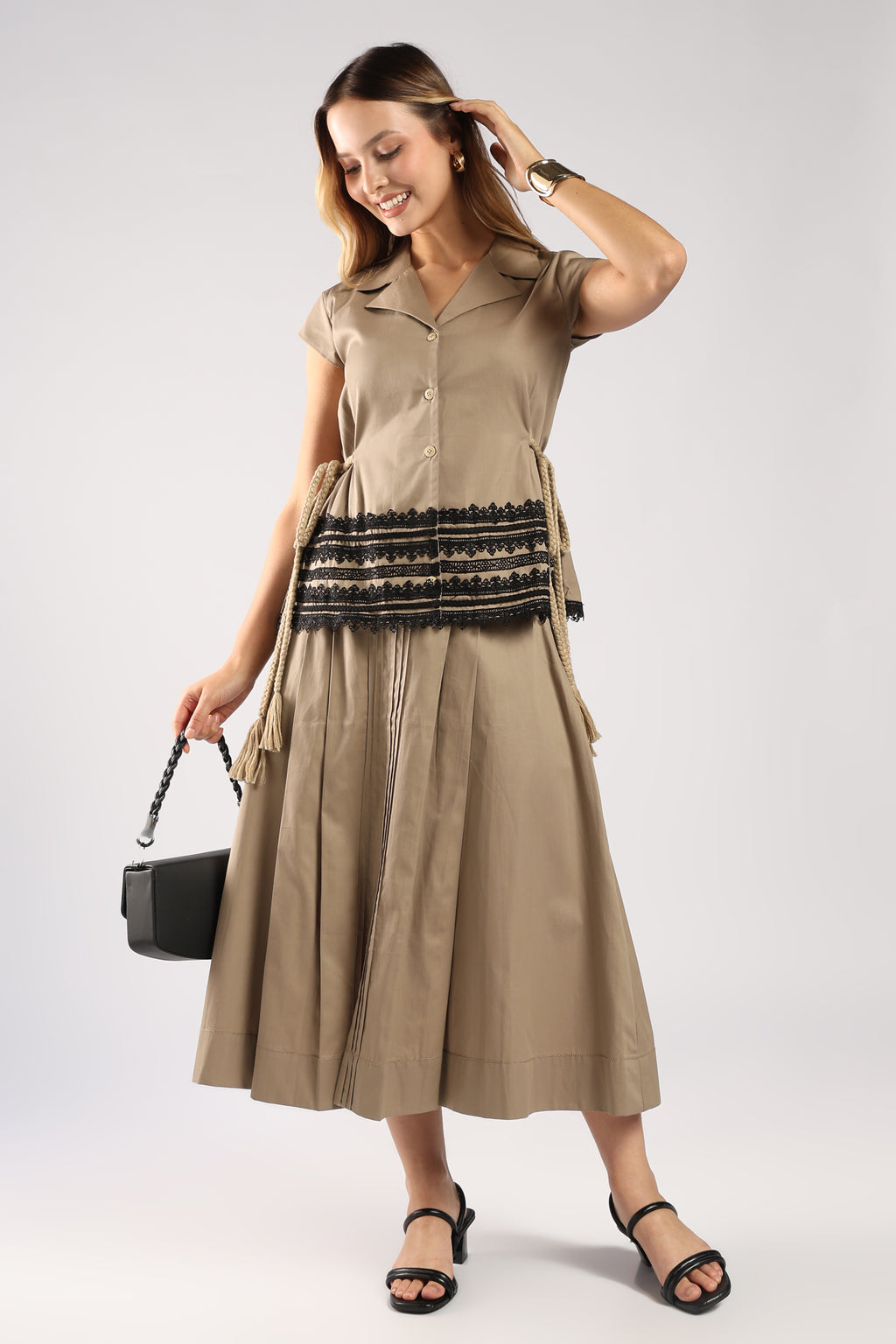 Front view of The Mia Khaki Women's Skirt Set showing the structured top and pleated skirt.