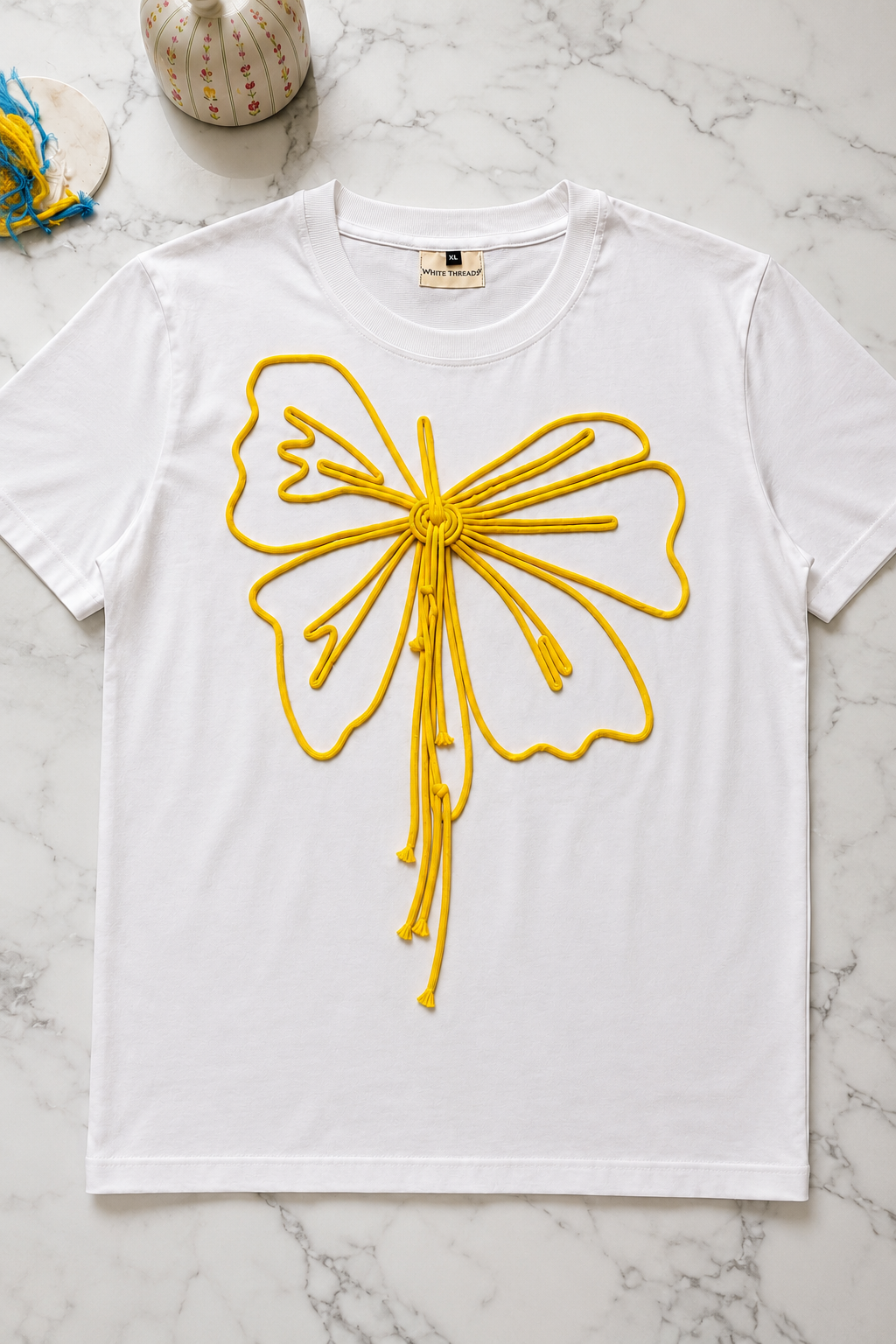 Close-up of the Butterfly Knot Women's T-Shirt highlighting the handcrafted butterfly cord detailing on French Terry fabric.