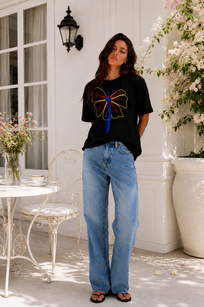 Model wearing the Butterfly Knot Women's T-Shirt in black styled with denim for an elevated everyday look.