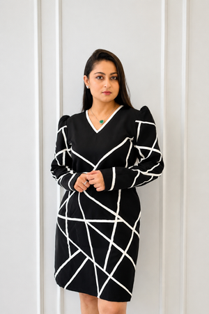 The Trim Line Women's Dress in black featuring hand-cut geometric leather detailing on imported crepe.