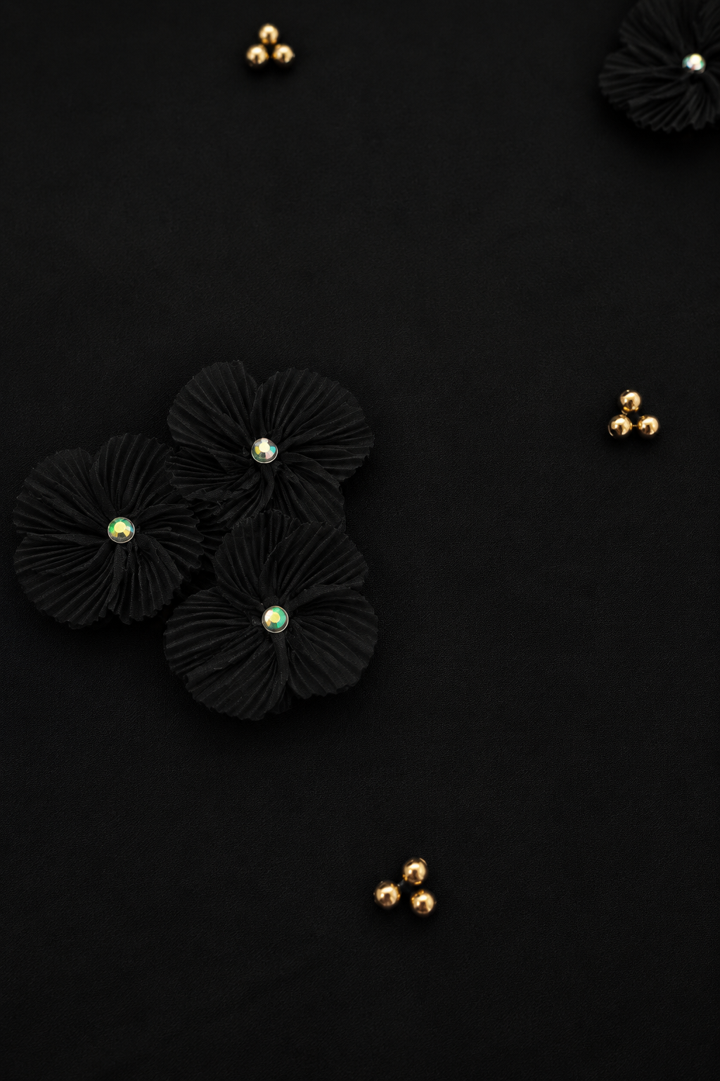 Close-up of the Midnight Pearl Women's T-Shirt highlighting the asymmetrical organza flower and pearl detailing on French Terry fabric.