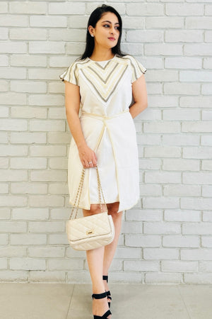 The Charm Women's Dress in white featuring geometric leather detailing around the neckline.