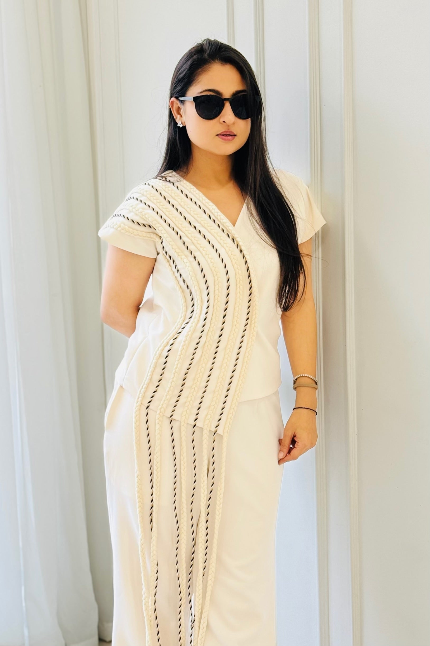 Close-up of The Braided White Co-ord Set highlighting the flowing braided detailing on the overlapping top.